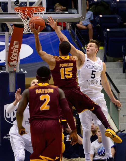 Scott Sommerdorf   |  The Salt Lake Tribune
Brigham Young Cougars guard Kyle Collinsworth (5) tries to block a shot by Central Michigan Chippewas Chris Fowler (15) during first half play. Central Michigan was tied with BYU 44-44 at the half, Friday, December 18, 2015.