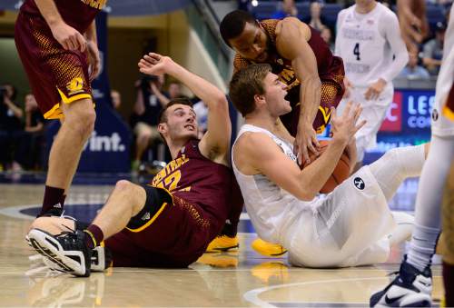 Scott Sommerdorf   |  The Salt Lake Tribune
Brigham Young Cougars guard Jake Toolson (15) calls timeout after coming up with a first half loose ball as Central Michigan Chippewas guard Josh Kozinski (12) turns to see. Central Michigan was tied with BYU 44-44 at the half, Friday, December 18, 2015.