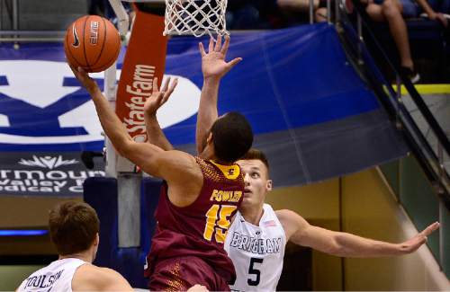 Scott Sommerdorf   |  The Salt Lake Tribune
Brigham Young Cougars guard Kyle Collinsworth (5) tries to block a shot by Central Michigan Chippewas Chris Fowler (15) during first half play. Central Michigan was tied with BYU 44-44 at the half, Friday, December 18, 2015.