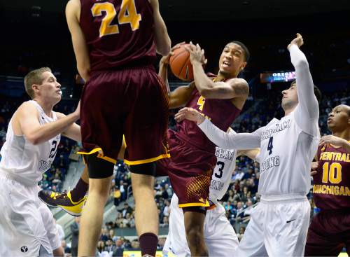 Scott Sommerdorf   |  The Salt Lake Tribune
Central Michigan Chippewas guard Rayshawn Simmons (4) rips down a rebound during first half play between Brigham Young Cougars forward Kyle Davis (21) and Brigham Young Cougars guard Nick Emery (4). Central Michigan was tied with BYU 44-44 at the half, Friday, December 18, 2015.
