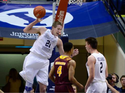 Scott Sommerdorf   |  The Salt Lake Tribune
Brigham Young Cougars forward Kyle Davis (21) celebrates a dunk over Central Michigan Chippewas guard Rayshawn Simmons (4) and team mate Brigham Young Cougars guard Zac Seljaas (2) looks on at right. BYU defeated Central Michigan 98-85, Friday, December 18, 2015.