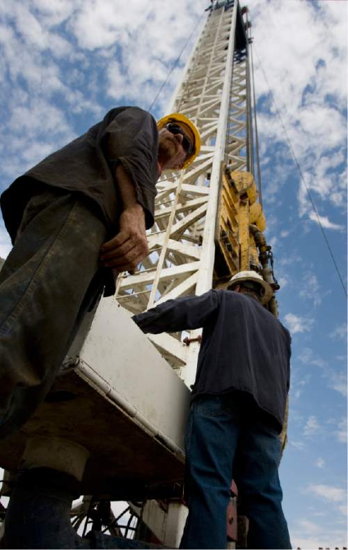 Kim Raff | The Salt Lake Tribune
Floorhands work on a super single oil rig's drilling platform in the Newfield Exploration Company's oil fields in Monument Butte near Roosevelt.