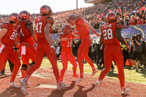 Trent Nelson  |  The Salt Lake Tribune
Utah Utes quarterback Travis Wilson (7) celebrates his first half touchdown with Utah Utes wide receiver Britain Covey (18), as Utah faces BYU in the Royal Purple Las Vegas Bowl, NCAA football at Sam Boyd Stadium in Las Vegas, Saturday December 19, 2015.