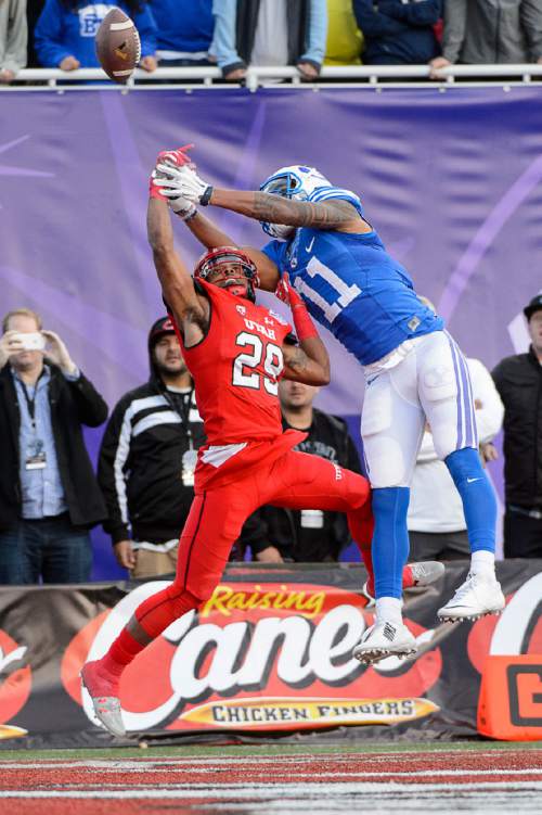 Trent Nelson  |  The Salt Lake Tribune
Utah Utes defensive back Reginald Porter (29) and Brigham Young Cougars wide receiver Terenn Houk (11) reach for a ball in the end zone, which went incomplete, in the fourth quarter as Utah faces BYU in the Royal Purple Las Vegas Bowl, NCAA football at Sam Boyd Stadium in Las Vegas, Saturday December 19, 2015.