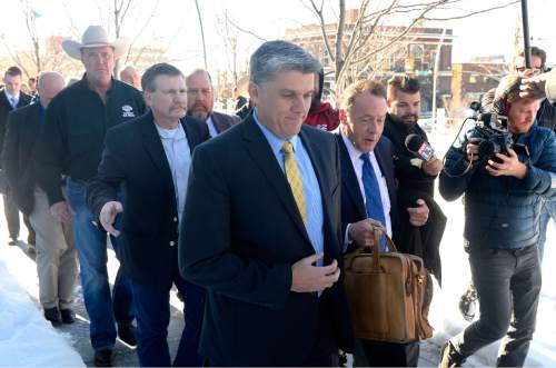 Al Hartmann  |  The Salt Lake Tribune
San Juan County Commissioner Phil Lyman, center, leaves sentencing hearing in Federal Court in Salt Lake City Friday Dec. 18.  He received 10 days in jail and three years probation for his role in an ATV protest ride down San Juan County's Recapture Canyon, which federal land managers closed to motorized use to protect ancient American Indian sites.