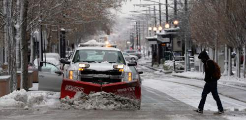 Al Hartmann  |  The Salt Lake Tribune
Pedestrian walks across icy, snow packed intersection at 200 South and Main Street in downtown Salt Lake City as crews clear the streets and sidewalks from the first winter snow storm of the season Tuesday December 3.