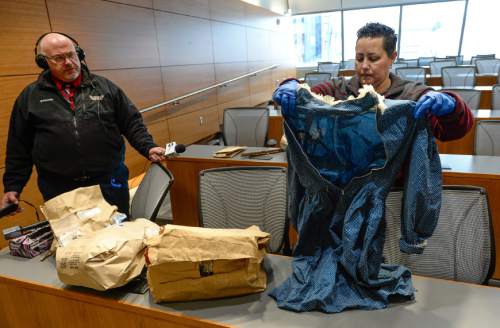 Francisco Kjolseth | The Salt Lake Tribune
Salt Lake police detective Hilary Gordon reveals a handmade dress as the department seeks the publicís assistance in identifying a white female, whose decomposing body was found on September 3, 1986, floating in a canal east of a sewage treatment plant at 1850 North Redwood Road. The State Medical Examinerís Office determined the death to be suspicious.