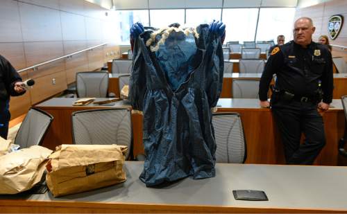Francisco Kjolseth | The Salt Lake Tribune
Salt Lake police detective Hilary Gordon reveals a handmade dress as the department seeks the public's assistance in identifying a white female, whose decomposing body was found on September 3, 1986, floating in a canal east of a sewage treatment plant at 1850 North Redwood Road. The State Medical Examiner's Office determined the death to be suspicious.
