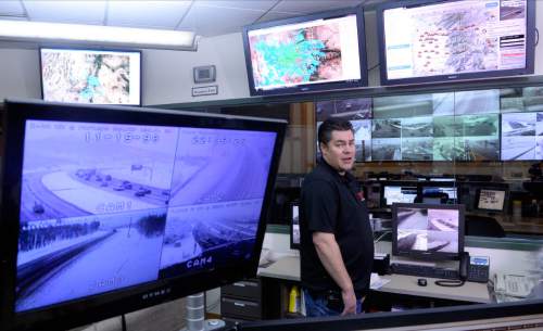 Al Hartmann  |  The Salt Lake Tribune
Jason Davis, Director of Operations for UDOT observes meterological information from Tuesday's Dec. 22 snowstorm while traffic operations engineers in the room behind him monitor UDOT's new snow plow monitoring system, "snowplow tracker."  The system provides near real-time location information for UDOT's fleet of more than 500 snow plows. It also allows for the public to go online and see which areas have been plowed.