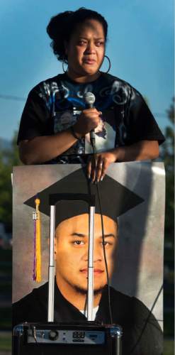 Steve Griffin  |  The Salt Lake Tribune
Siola'a Nau, sister of, Siale Angilau, who was shot and killed in the Salt Lake City federal courthouse, holds a poster of her brother as she talks during the Justice4Siale Vigil on the courthouse plaza in Salt Lake City, Utah Wednesday, June 11, 2014.  Glendale community members have organized a coalition called the "Raise your Pen Coalition."