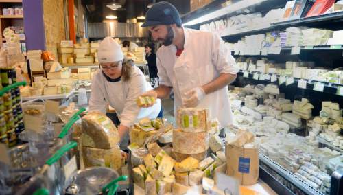 Al Hartmann  |  The Salt Lake Tribune
Cheese mongers Jen Brown and Daniel Wambaugh organize and stack artisan cheeses at Liberty Heights Fresh in Salt Lake City for the Christmas season.