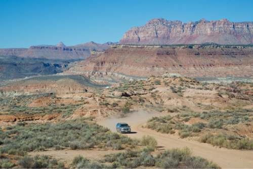 (Lynn R. Johnson / Special to The Salt Lake Tribune - A lone vehicle driving through the Smithsonian Butte area of Southern Utah.  Best traversed in a four wheel vehicle, some sections of the Butte are not for the faint of heart, with some stretch aptly named "Cry Baby Hill."