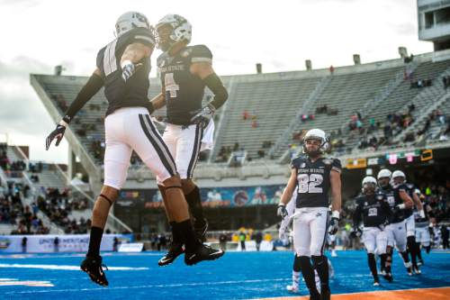 Chris Detrick  |  The Salt Lake Tribune
Utah State Aggies wide receiver Brandon Swindall (11) celebrates his touchdown with Utah State Aggies wide receiver Hunter Sharp (4) during the Famous Idaho Potato Bowl at Albertsons Stadium in Boise, Idaho Tuesday December 22, 2015.  Akron Zips lead Utah State Aggies 13-7 at halftime.