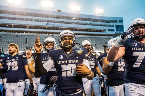 Chris Detrick  |  The Salt Lake Tribune
Utah State Aggies quarterback Chuckie Keeton (16) and his teammates sing the Fight Song after the Famous Idaho Potato Bowl at Albertsons Stadium in Boise, Idaho Tuesday December 22, 2015.  Akron Zips defeated Utah State Aggies 23-21.