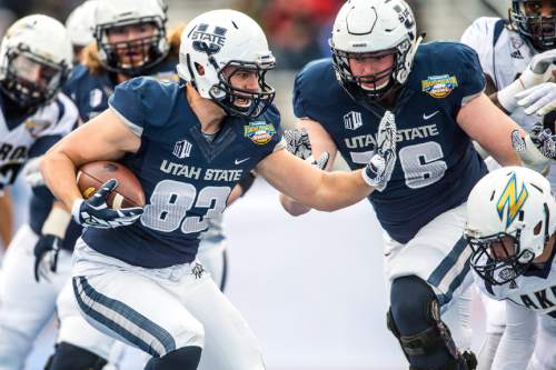 Chris Detrick  |  The Salt Lake Tribune
Utah State Aggies tight end Wyatt Houston (83) runs the ball during the Famous Idaho Potato Bowl at Albertsons Stadium in Boise, Idaho Tuesday December 22, 2015.  Akron Zips lead Utah State Aggies 13-7 at halftime.