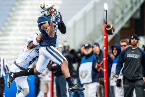 Chris Detrick  |  The Salt Lake Tribune
Utah State Aggies wide receiver Hunter Sharp (4) can't make a catch while being covered by Akron Zips cornerback DeAndre Scott (6) during the Famous Idaho Potato Bowl at Albertsons Stadium in Boise, Idaho Tuesday December 22, 2015.  Akron Zips lead Utah State Aggies 13-7 at halftime.