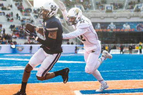 Chris Detrick  |  The Salt Lake Tribune
Utah State Aggies wide receiver Brandon Swindall (11) scores a touchdown past Akron Zips safety Zach Guiser (32) during the Famous Idaho Potato Bowl at Albertsons Stadium in Boise, Idaho Tuesday December 22, 2015.  Akron Zips lead Utah State Aggies 13-7 at halftime.