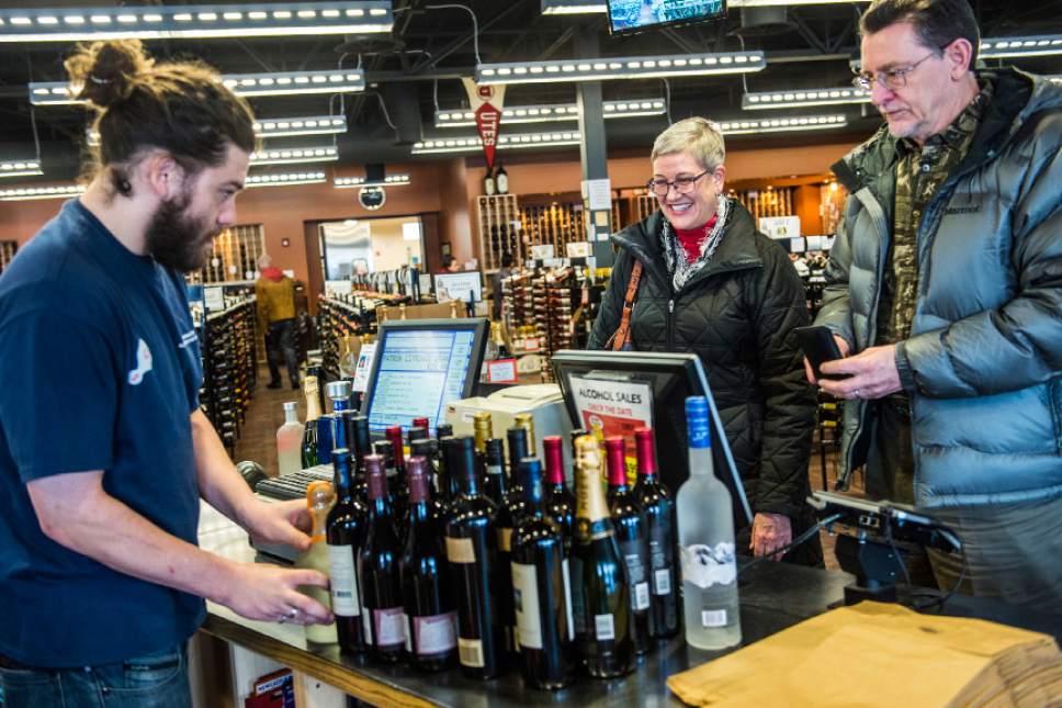 Chris Detrick  |  The Salt Lake Tribune
Trevor Landsaw rings up Candice Johnson and Ed Ashwood's wine and liquor purchase at the Utah Wine Store on 280 Harris Avenue Thursday December 24, 2015.