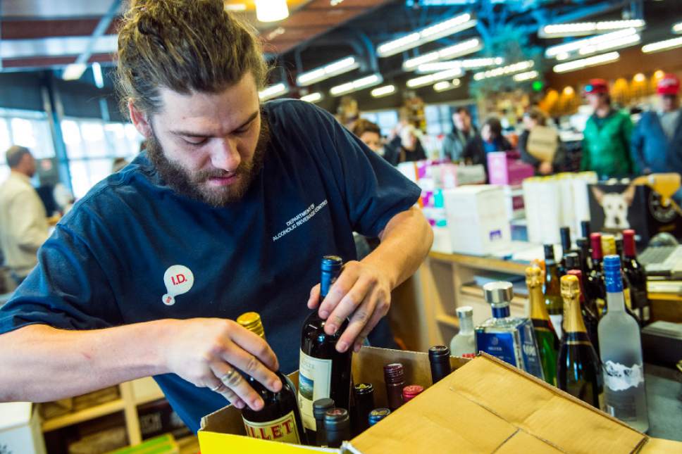 Tribune file photo
An employee packs wine and liquor for a customer at the Utah Wine Store in Salt Lake City in 2015.