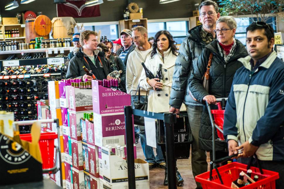 Chris Detrick  |  The Salt Lake Tribune
Customers wait in line to check out at the Utah Wine Store on 280 Harris Avenue Thursday December 24, 2015.