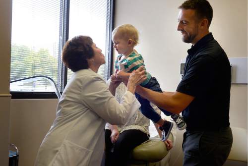Scott Sommerdorf   |  The Salt Lake Tribune
Dr. Vicki L. Macy, MD, OBGYN, leans in to give a kiss to two year old Ryan Wangsgard as his father David Wangsgard during their last pregnancy check-in appointment with Dr. Macy at Salt Lake Regional Medical Center, Wednesday, September 30, 2015. Dr. Macy delivered the Wangsgard's son, Ryan.