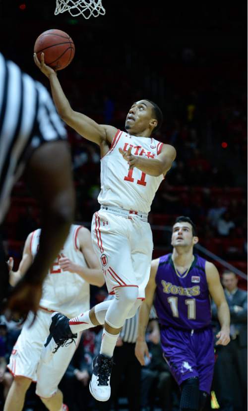 Francisco Kjolseth | The Salt Lake Tribune
Utah Utes guard Brandon Taylor (11) sails one in agains the College of Idaho in game action at the Huntsman Center on Monday night in the final non-conference game of the season.
