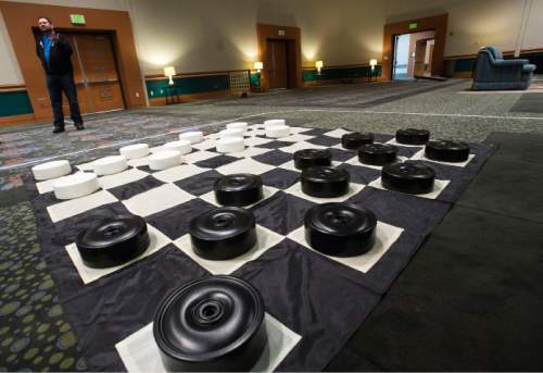 Steve Griffin  |  The Salt Lake Tribune

 EVE creative director Topher Horman stands in the "not your parents" game room which is the newest attraction at this year's EVE Winterfest, which starts Tuesday, Dec. 29, The room includes giant games like checkers, dominoes and Jenga, but  also re-creates a giant living room where people can play play video games, specifically Minecraft, using laptops provided or there own devices. Workers began setting up for the event Monday morning at the Salt Palace Convention Center in Salt Lake City, Monday, December 28, 2015.