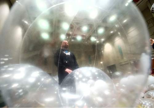 Steve Griffin  |  The Salt Lake Tribune

 EVE creative director Topher Horman stands with giant beach balls as they are inflated for this year's EVE Winterfest, which starts Tuesday, Dec. 29, 2015. Workers began setting up for the event Monday morning at the Salt Palace Convention Center in Salt Lake City, Monday, December 28, 2015.