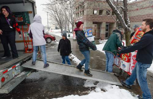 Francisco Kjolseth  |  The Salt Lake Tribune
Kandie, a therapy dog owned by Kelly Lawson, watches as numerous volunteers and employees at the Salt Lake County Animal Services help unload a truck full of pet supplies and donations from the three-month I'm Not a Monster holiday drive.