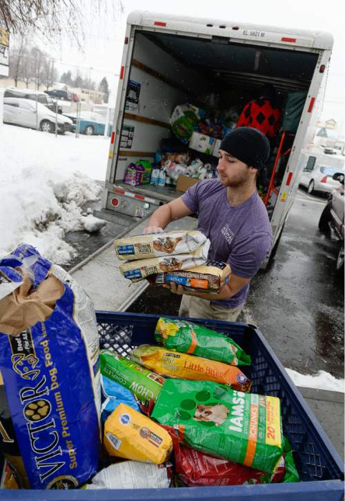 Francisco Kjolseth | The Salt Lake Tribune
Austin Lewis joins many others unloading a truck full of donated pet supplies at the Salt Lake County Animal Services on Tuesday. Organized by Kelly Lawson, whose therapy dog Kandie was the face of the drive, marks the third year in a row she has held it. She hopes this year tops the estimated $14,000 worth of last year's donations.