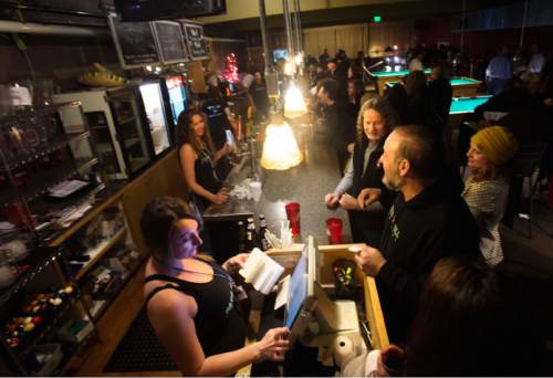 Steve Griffin  |  The Salt Lake Tribune

Fats Grill owner Mario Caligiluri, right,  talks with bar staff and guests during the bar's last night of business in Salt Lake City, Wednesday, December 30, 2015. The long time bar and grill will be torn down and be replaced by a office tower.