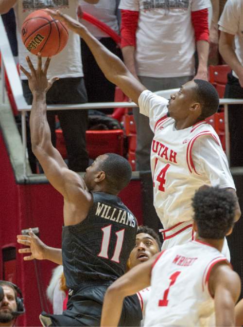 Rick Egan  |  The Salt Lake Tribune

Utah forward Dakarai Tucker (14) tries to get his hand on a shot by San Diego State Aztecs guard D'Erryl Williams (11), in basketball action, as the Utes defeated the San Diego State Aztecs 81-76, at the Huntsman Center, Tuesday, November 10, 2015.