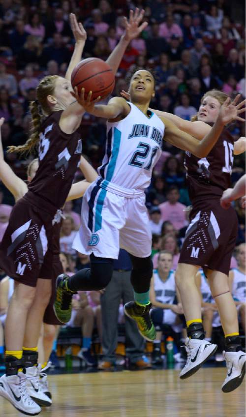 Leah Hogsten  |  The Salt Lake Tribune
Juan Diego's Monique Mills slips between Morgan's Lily Henry and Brooklyn Hurlbut .  Juan Diego High School girls basketball team leads Morgan High School 26-17 at the half during their 3A State Championship game, Saturday, February 28, 2015 at the Maverick Center.
