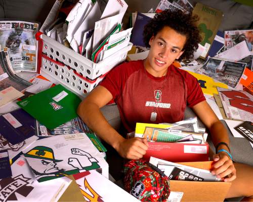 Leah Hogsten  |  The Salt Lake Tribune
Brighton High School football star Simi Fehoko is surrounded by the thousands of pieces of correspondence he's received from universities across the country during his recruitment,  July 16, 2015. Fehoko has committed to Stanford.