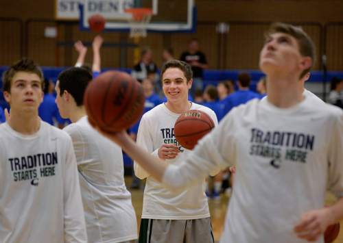 Scott Sommerdorf   |  The Salt Lake Tribune
Copper Hills' Stockton Shorts, center, smiles as he warms up with teammates prior to the match at Bingham. Behind Shorts' clutch free throws down the stretch, Copper Hills upset Bingham on the road, Friday, February 6, 2015.