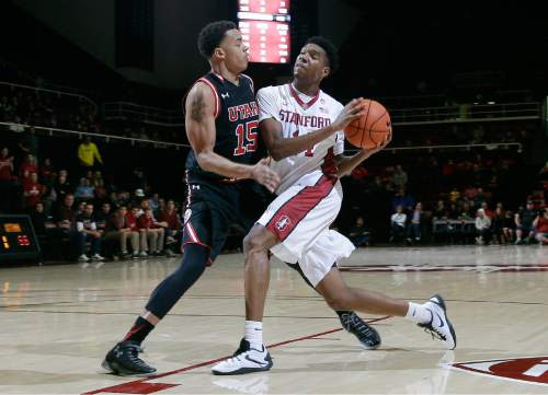 Stanford guard Marcus Sheffield (14) drives to the basket as Utah guard Lorenzo Bonam (15) defends during the second half of an NCAA college basketball game Friday, Jan. 1, 2016, in Stanford, Calif. Stanford won 70-68 in overtime. (AP Photo/Marcio Jose Sanchez)