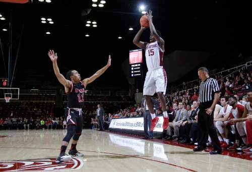 Stanford guard Marcus Allen (15) shoots over Utah guard Brandon Taylor during the second half of an NCAA college basketball game Friday, Jan. 1, 2016, in Stanford, Calif. Stanford won 70-68 in overtime. (AP Photo/Marcio Jose Sanchez)