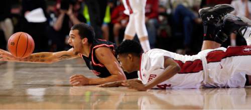 Utah forward Brekkott Chapman, left, battles for a loose ball against Stanford guard Marcus Sheffield during the second half of an NCAA college basketball game Friday, Jan. 1, 2016, in Stanford, Calif. Stanford won 70-68 in overtime. (AP Photo/Marcio Jose Sanchez)