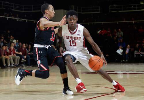 Stanford guard Marcus Allen (15) is defended by Utah guard Brandon Taylor during the second half of an NCAA college basketball game Friday, Jan. 1, 2016, in Stanford, Calif. Stanford won 70-68 in overtime. (AP Photo/Marcio Jose Sanchez)