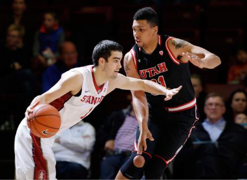 Stanford guard Christian Sanders, left, is defended by Utah forward Jordan Loveridge during the first half of an NCAA college basketball game Friday, Jan. 1, 2016, in Stanford, Calif. (AP Photo/Marcio Jose Sanchez)