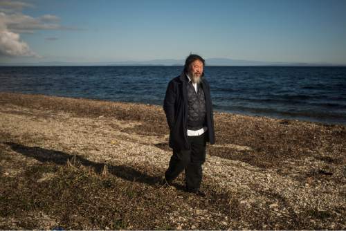 Chinese activist and artist Ai Weiwei walks on a beach next to the town of Mytilini, on the Greek island of Lesbos, Friday, Jan. 01, 2016. The Chinese artist visited the island of Lesbos is solidarity with refugees and migrants who continue to arrive on a daily basis hoping to make their way into Europe.   (AP Photo/Santi Palacios)