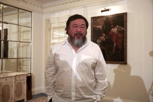 Chinese activist and artist Ai Weiwei poses for a photograph following a news conference in Athens, Friday, Jan. 1, 2016.  The Chinese artist visited the island of Lesbos is solidarity with refugees and migrants who continue to arrive on a daily basis hoping to make their way into Europe.  (AP Photo/Yorgos Karahalis)