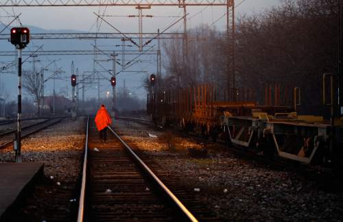 A migrant walks along railway tracks at the railway station in the southern Serbian town of Presevo, Wednesday, Dec. 23, 2015.  As 2015 ends, boat-loads continue to reach the shores of Greek islands from the nearby Turkish coast, while thousands of migrants unlikely to receive refugee status are stranded along the Balkan migrant route, their hopes of reaching the prosperous northern EU countries in jeopardy. (AP Photo/Darko Vojinovic)