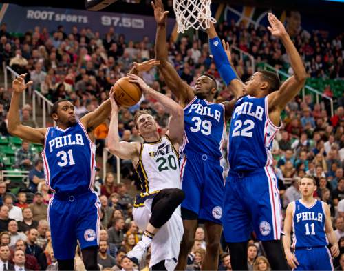 Lennie Mahler  |  The Salt Lake Tribune

Jazz guard Gordon Hayward draws a foul as he is guarded by Hollis Thompson, Jerami Grant and Richaun Holmes in the first half of a game against the Philadelphia 76ers at Vivint Smart Home Arena, Monday, Dec. 28, 2015.