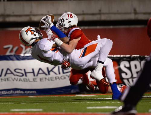 Scott Sommerdorf   |  The Salt Lake Tribune
With East DB Jordan Anderson (18) draped all over him, Timpview WR Samson Nacua (1) still made this catch inside the 5 yard line to set up a Timpview TD. East led Timpview 21-14 at the half in the 4A championship game, Friday, November 20, 2015.