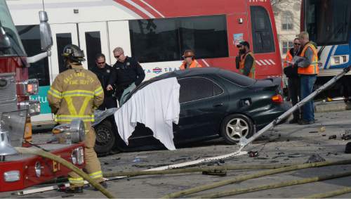 Al Hartmann  |  The Salt Lake Tribune
Emergency crews respond to a fatal car accident of driver at 600 West and North Temple when it collided with a TRAX train Monday Jan. 4.