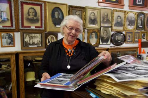 Lynn R. Johnson  |  Special to The Salt Lake Tribune

Kanab Heritage Museum curator Deanna Glover looking over material from the golden age of movie making in the area.  The museum's shelves are lined with movie and television scripts, many of them autographed, along with a wealth of photo albums of film stars.  Mrs. Glover smiles when she recalls the day a donkey suddenly died during the filming of a Western move and, in an effort to maintain film continuity, a local beauty shop operator was called to the set to dye the hair of the animal's replacement.
