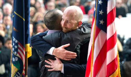 Steve Griffin  |  The Salt Lake Tribune

Salt Lake City Council member Derek Kitchen, right, hugs his husband Moudi Sbeity after taking the Oath of Office administered by city recorder Cindi Mansell, during ceremony at the City & County Building in Salt Lake City, Monday, January 4, 2016. Kitchen is joined by his for the event.