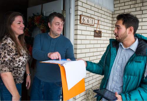 Rick Egan  |  The Salt Lake Tribune

Sharilyn and Gavin Grooms (left) chat with Tanner Leatham (right) as he gathers signatures for Sen. Curt Bramble, at their home in Provo, Monday, January 4, 2016.