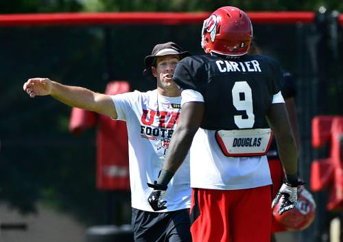 Scott Sommerdorf   |  The Salt Lake Tribune
Utah safties coach Morgan Scalley talks with S Tevin Carter after a play at Utah football practice with pads on the baseball field, Thursday, August 7, 2014.